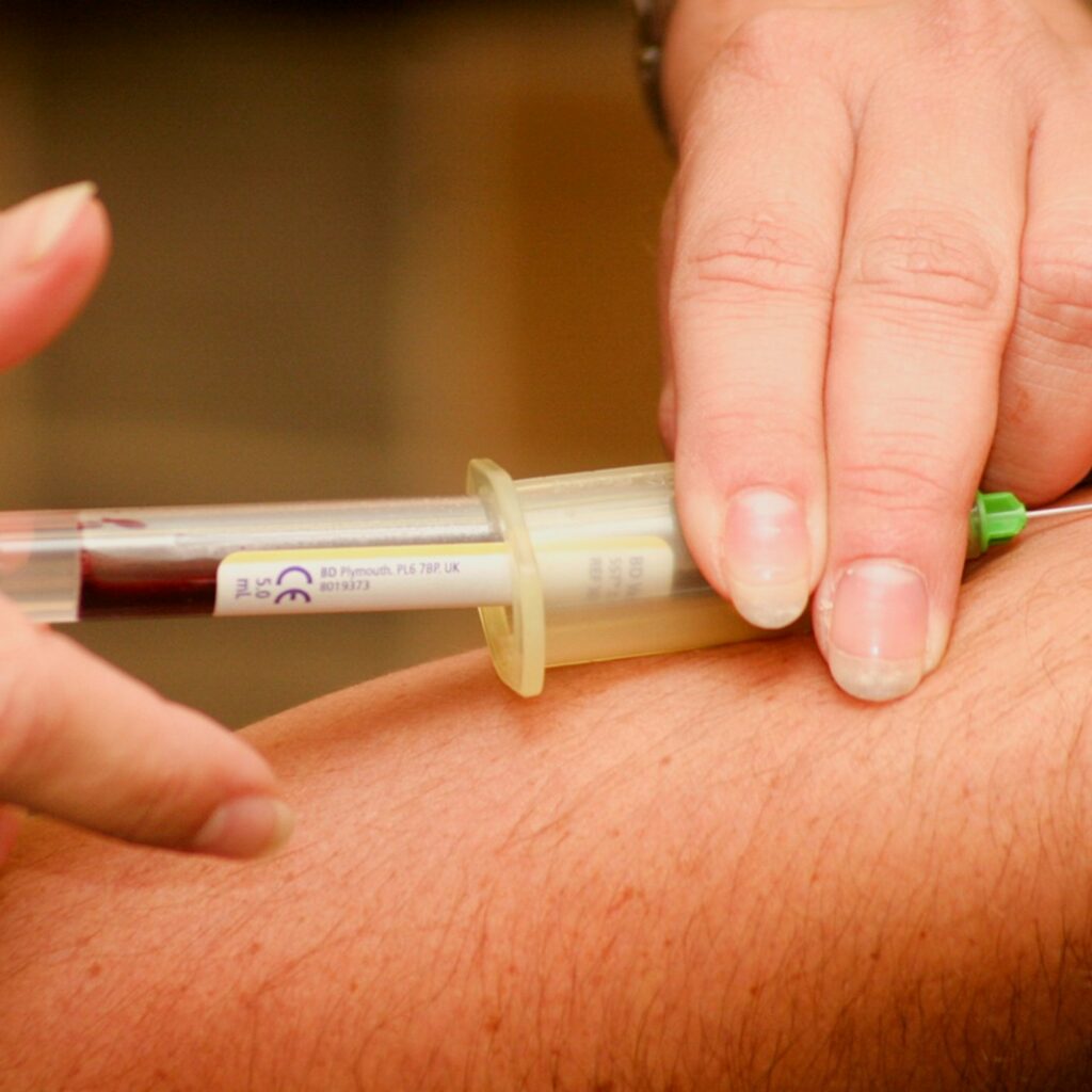 person injecting syringe